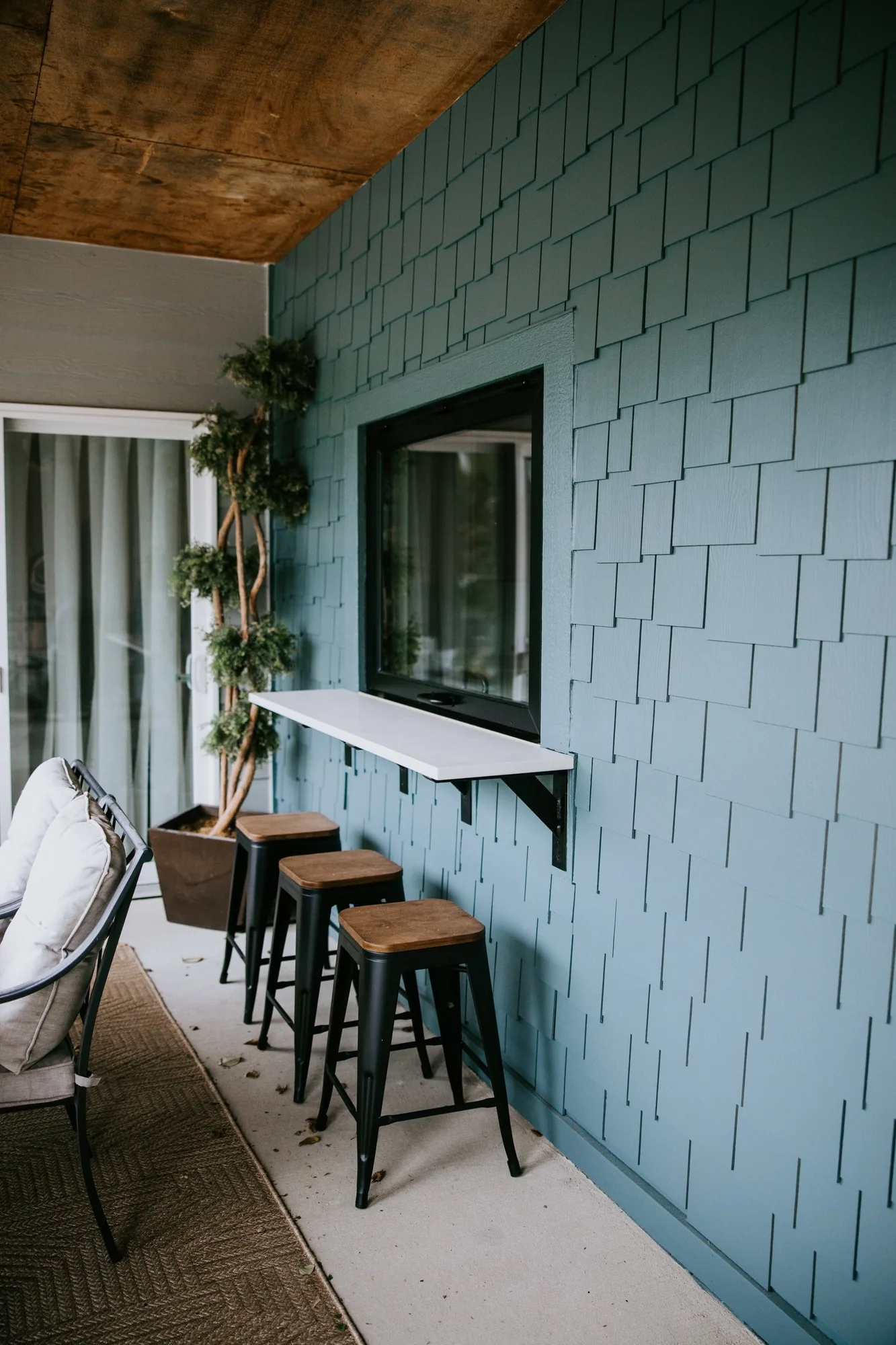 A remodeled bar area with a shingled wall built by Pride Built Homes