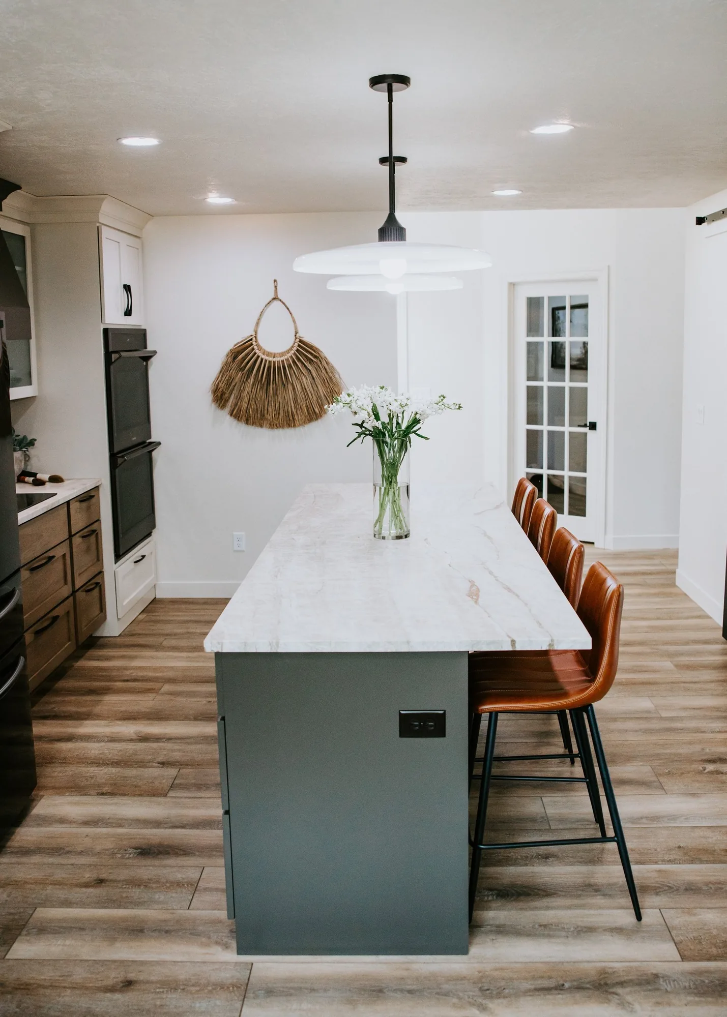 A remodeled kitchen with a stone island built by Pride Built Homes